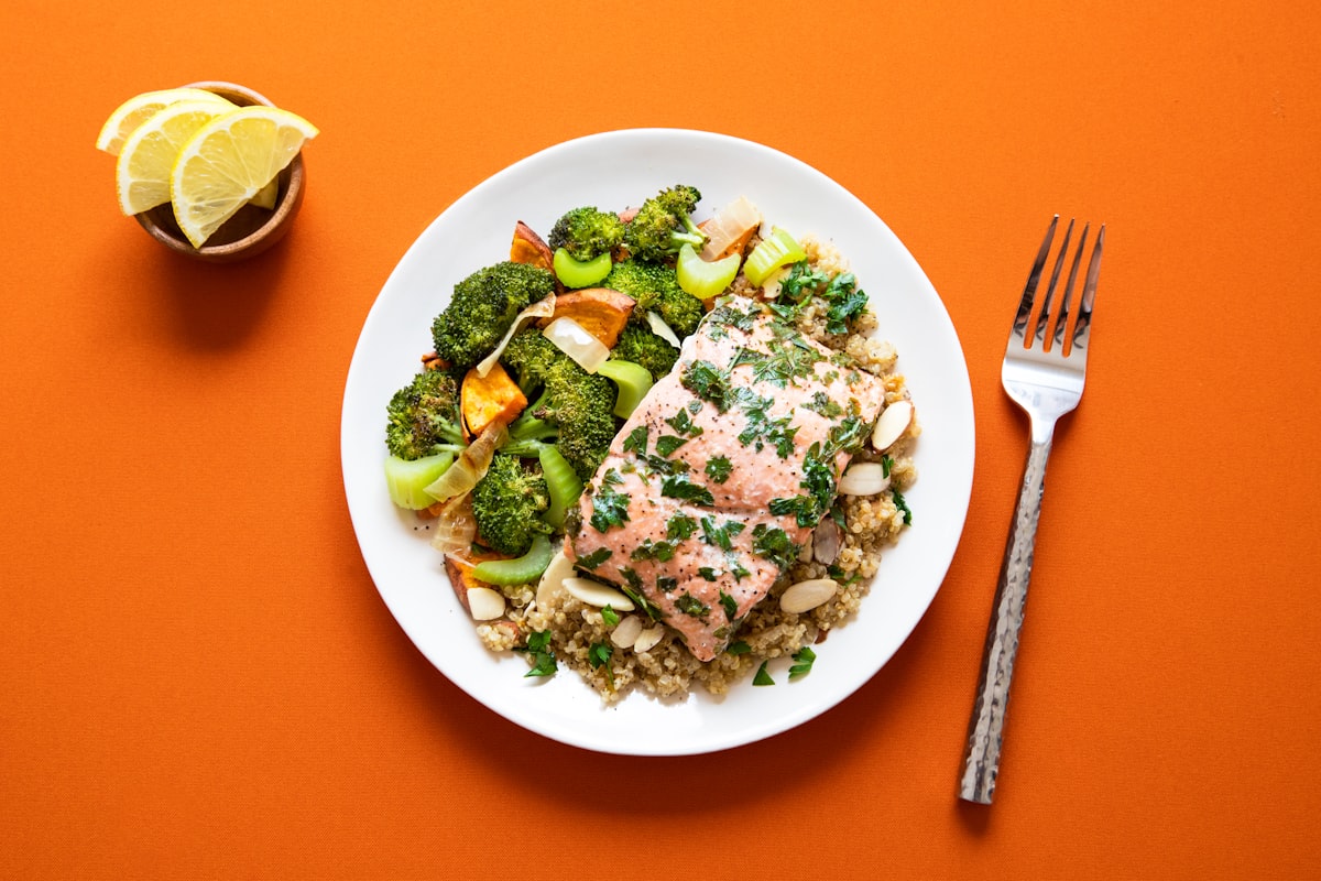 Fresh vegetables and healthy whole foods arranged on a wooden surface